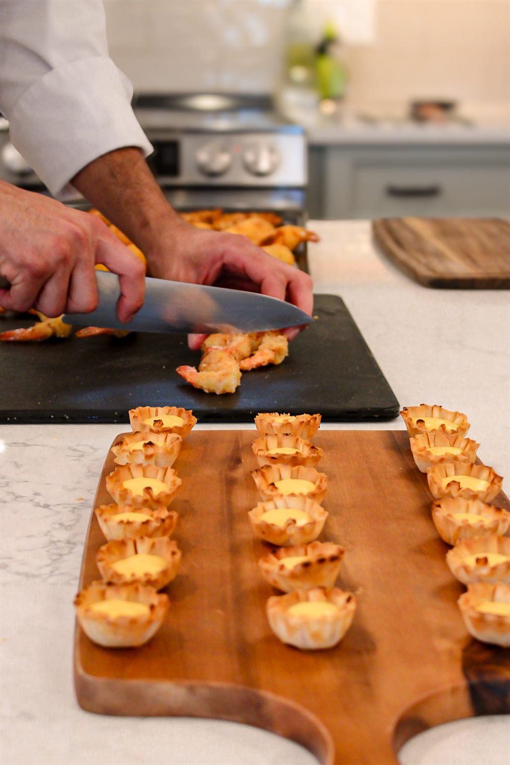 Chef Kaynan plating shrimp canapes for a private event
