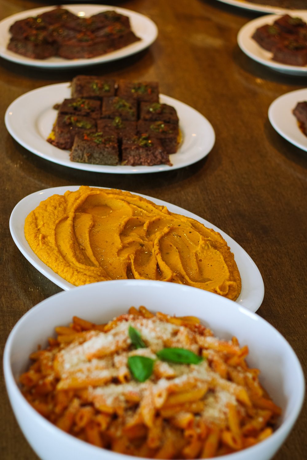 Family-style private dinner with chimichurri beef, sweet potato puree and penne pomodoro