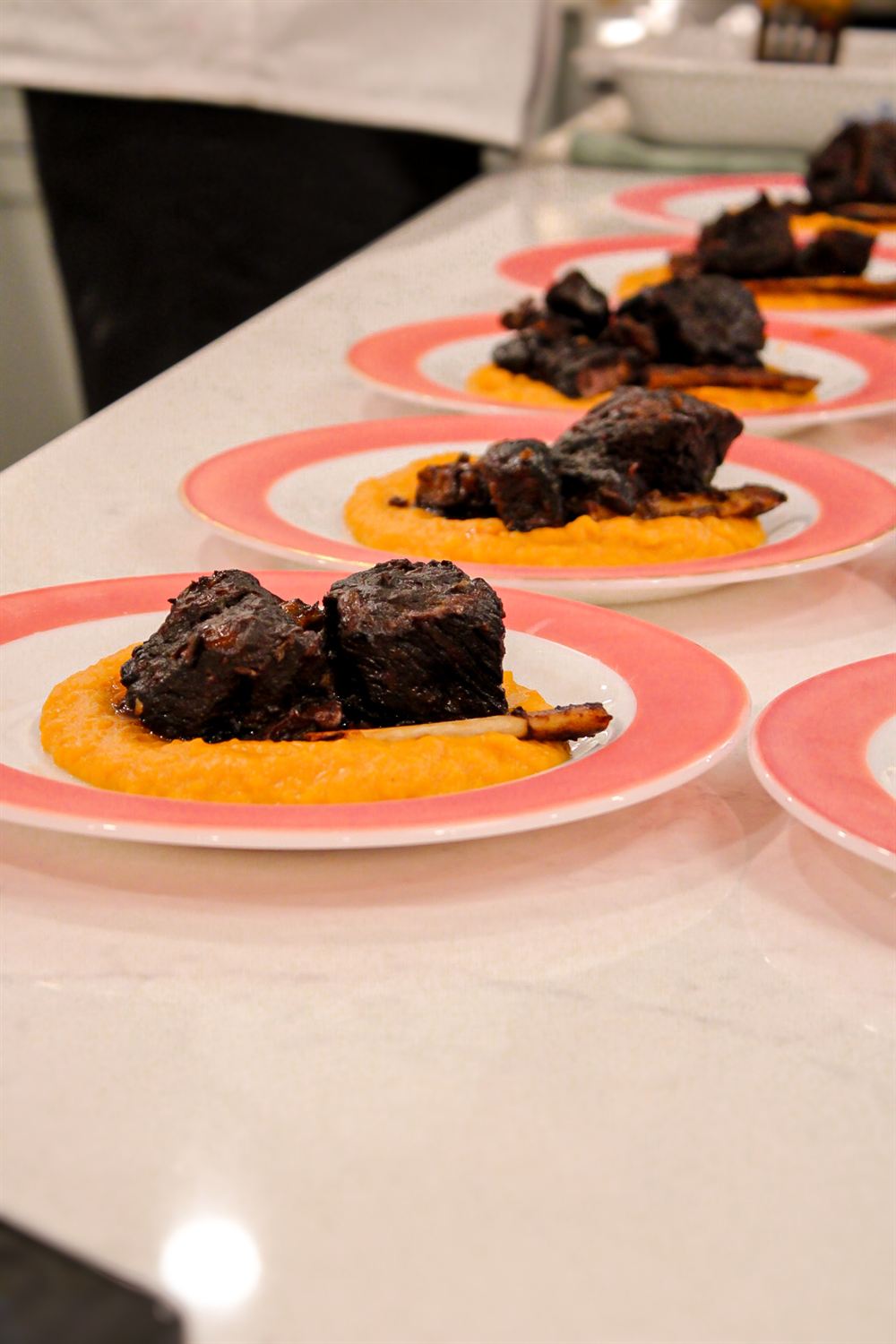 Short rib main course plated with sweet potato puree