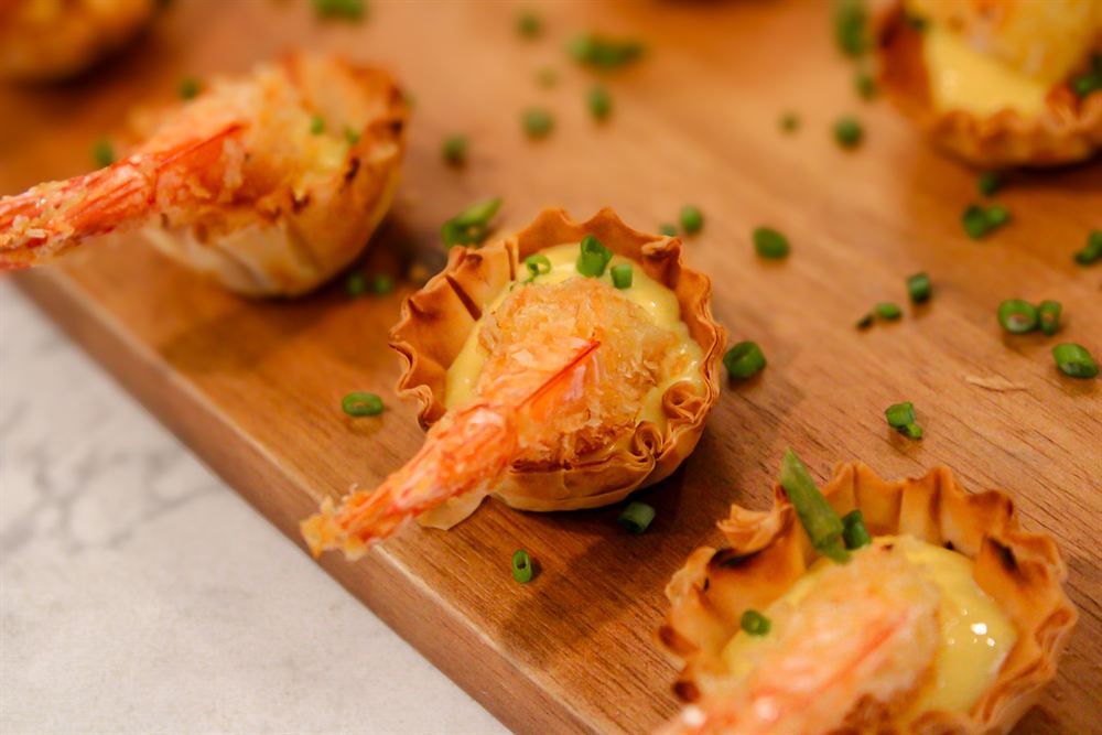 Chef Kaynan plating passed bites for a private event