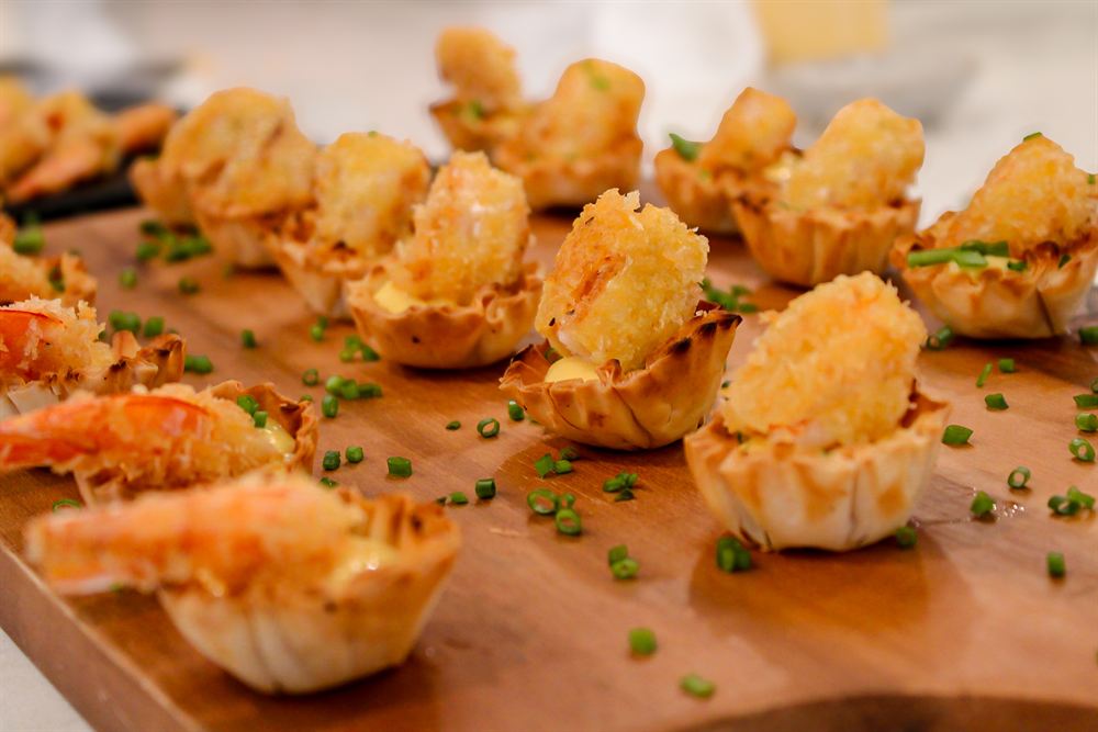 A full board of shrimp canapes with chives