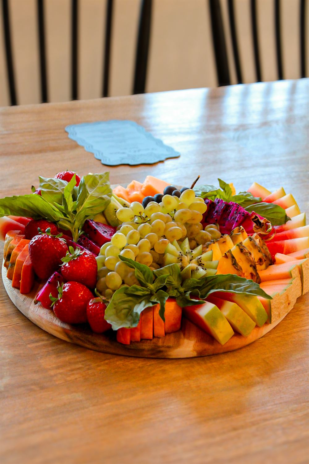 Tropical fruit board close up with watermelon, kiwi and grapes
