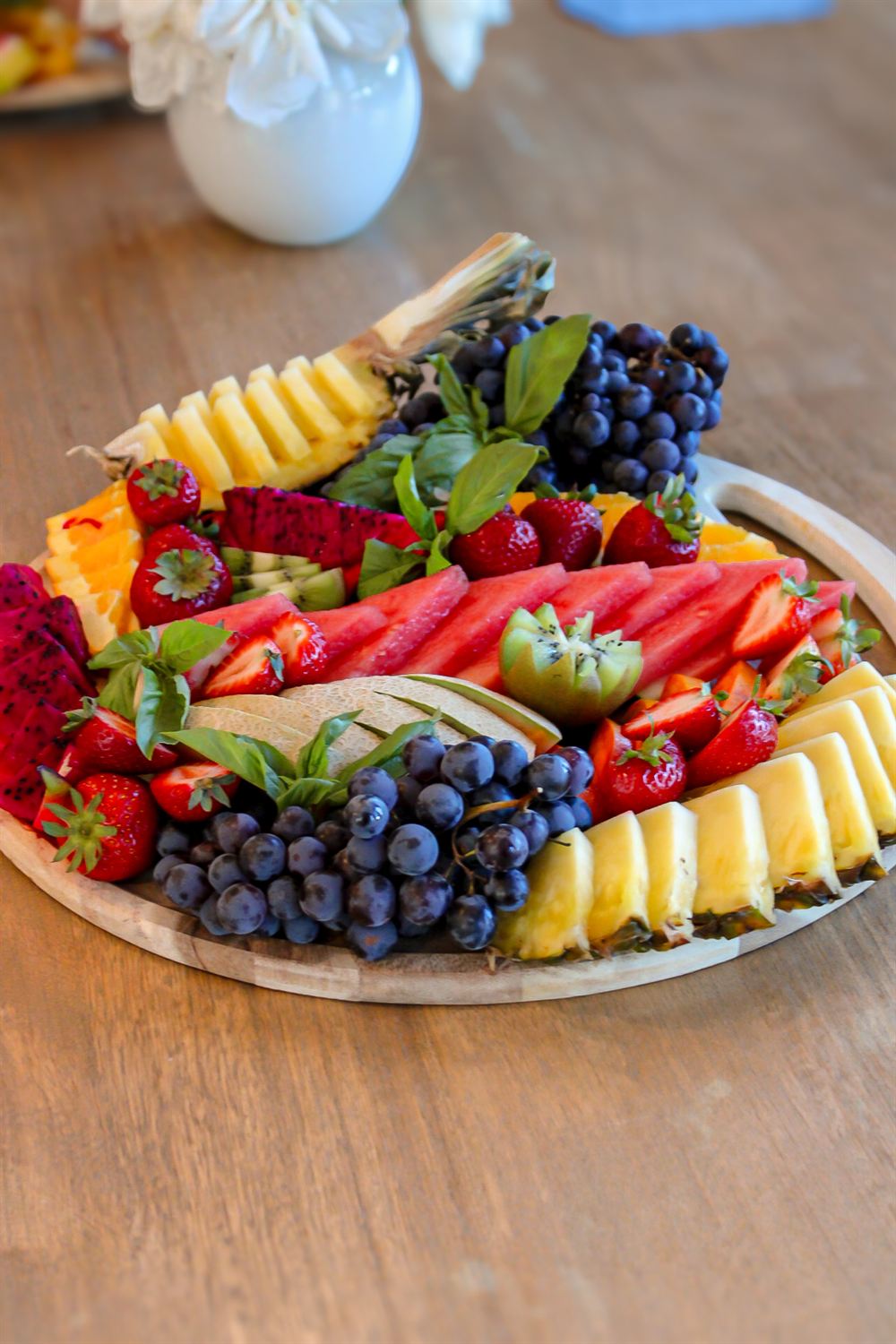 Tropical fruit board with grapes, pineapple and dragon fruit